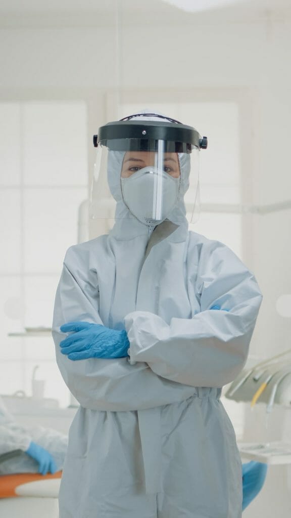 Portrait of dentist standing in hazmat suit for virus protection